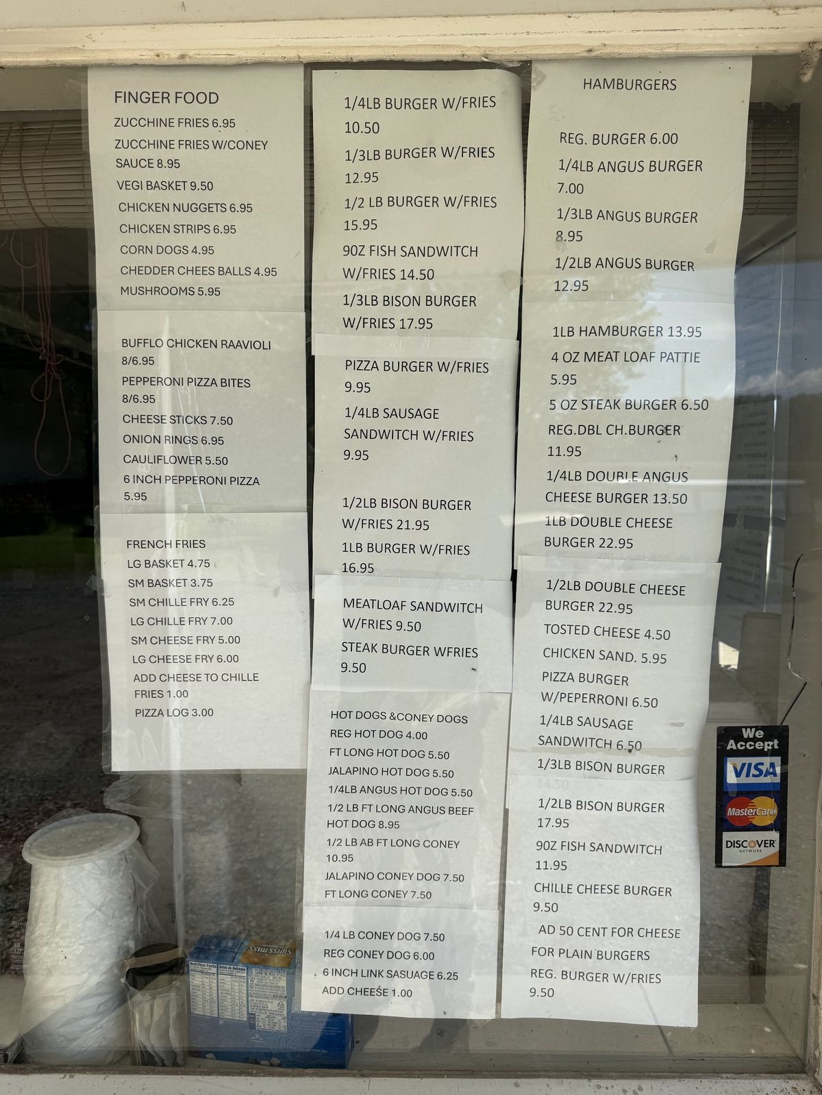 Menu boards for finger food, burgers and hot dogs posted in the window