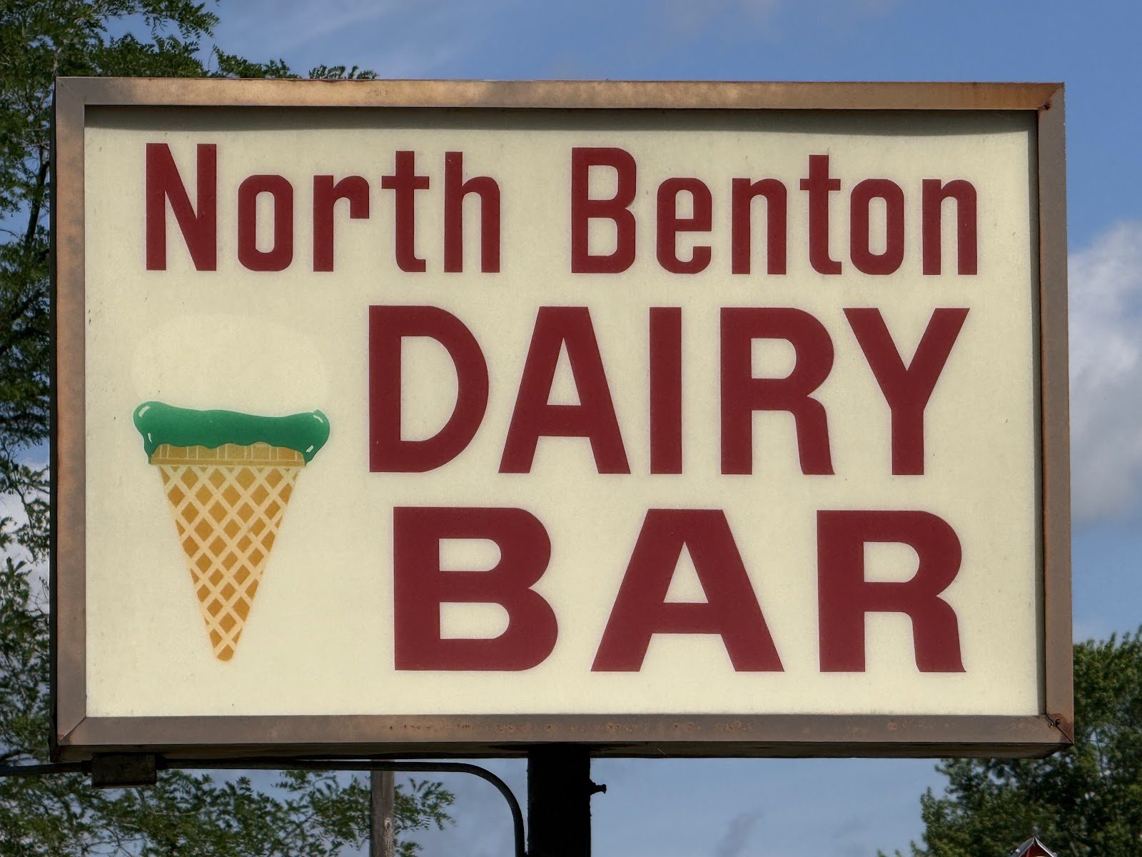 The North Benton Dairy Bar sign with its ice cream cone against a blue sky